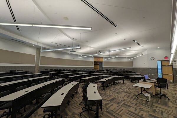 Back of room view of student tiered fixed-table and chair seating 