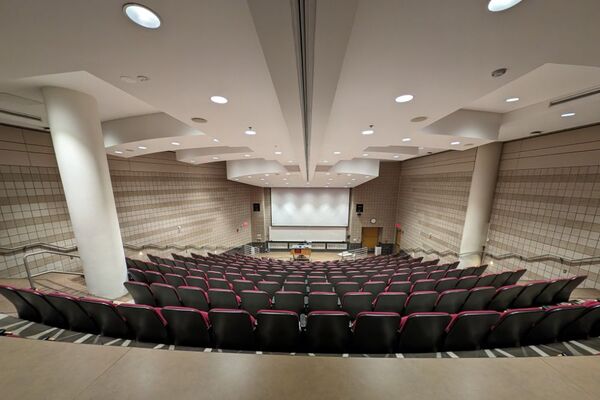 Front of room view with lectern in front of markerboard, exit at both front corners