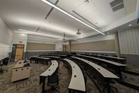 Back of room view of student tiered fixed-table and chair seating 