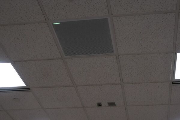 White 2¿ x 2¿ tile mounted in the ceiling to provide microphone coverage over student seating