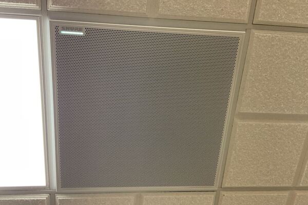 White 2¿ x 2¿ tile mounted in the ceiling to provide microphone coverage over student seating