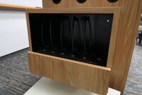 Pedestal - inside view of drawer showing assistive listening devices in charging base