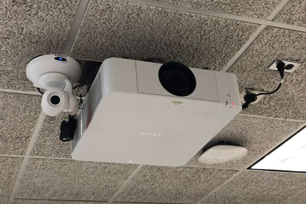 Camera mounted to ceiling and instructor enabled adjustments to the lens to allow the instructor to be "seen" by the camera in more locations around the room