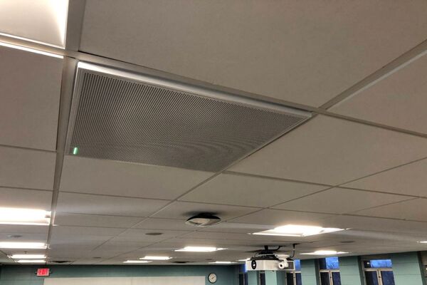 White 2¿ x 2¿ tile mounted in the ceiling to provide microphone coverage over student seating