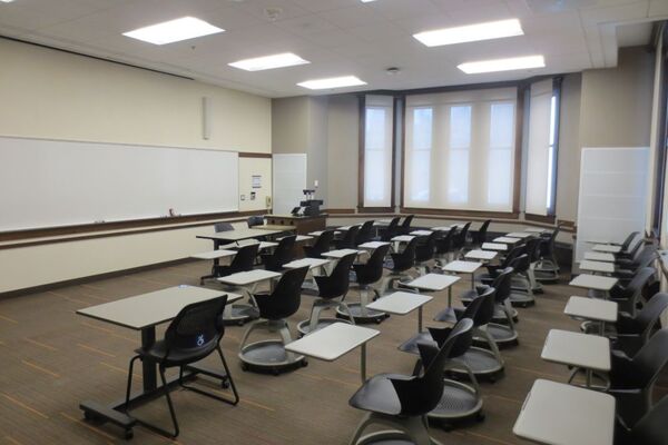 Front of room view with lectern on right in front of markerboard 