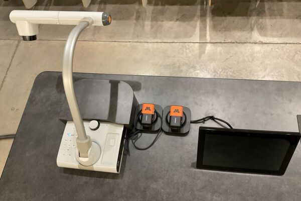 Pedestal - view showing assistive listening devices in charging base