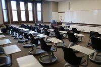 Front of room view with lectern on left in front of markerboard 