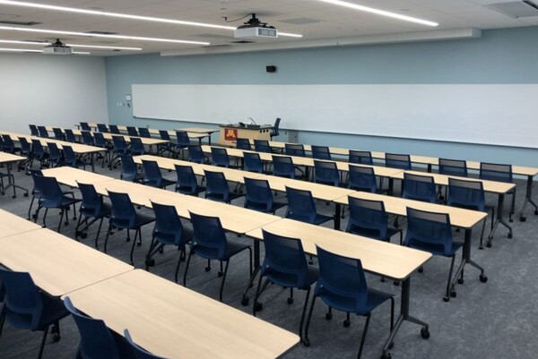 Front of room view with lectern in center in front of markerboard 