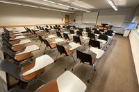 Front of room view with lectern on right in front of markerboard