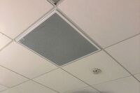 White 2¿ x 2¿ tile mounted in the ceiling to provide microphone coverage over student seating