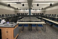 Back of room view of student tiered fixed table and chair seating 