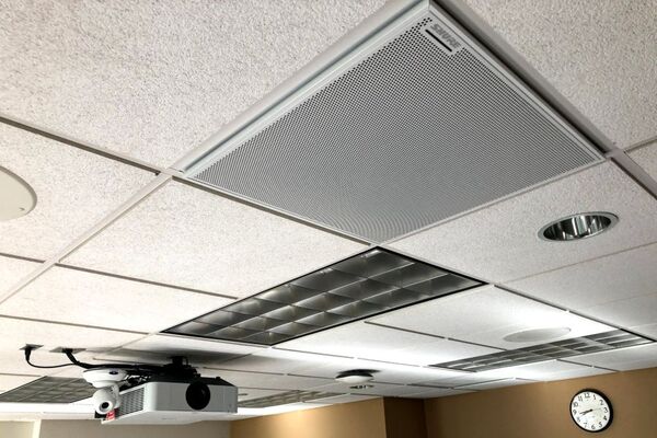 White 2¿ x 2¿ tile mounted in the ceiling to provide microphone coverage over student seating