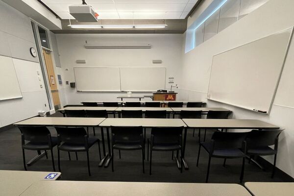 Front of room view with lectern on right in front of markerboard 