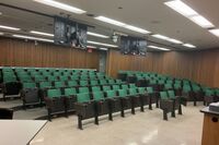 Back of room view of student auditorium seating and exit door at rear of room